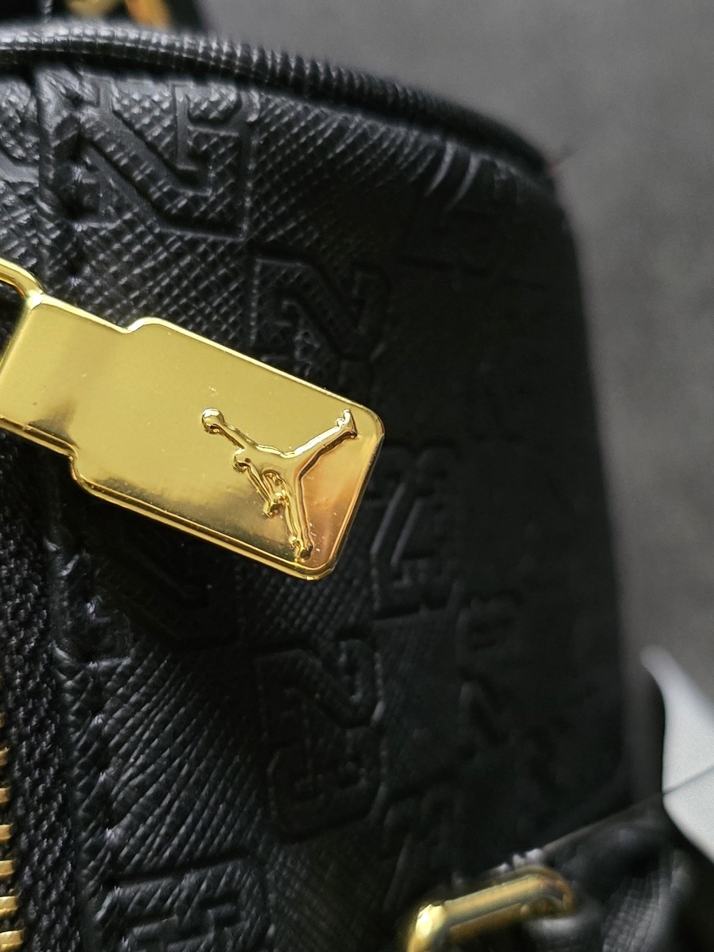 A black Jordan Monogram Mini Duffle Bag With Jump Man On It - Picture 5 of 10